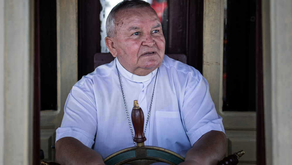 Bishop Marcos Patek, bishop of the Diocese of Coari, is seen at the helm of the boat 'Cathedral', which belongs to the Diocese of Coari, Amazonas, Brazil, on May 8, 2022. Photo: Raphael Alves